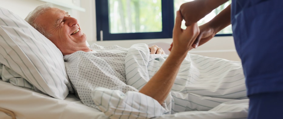 Senior holding hands of caregiver